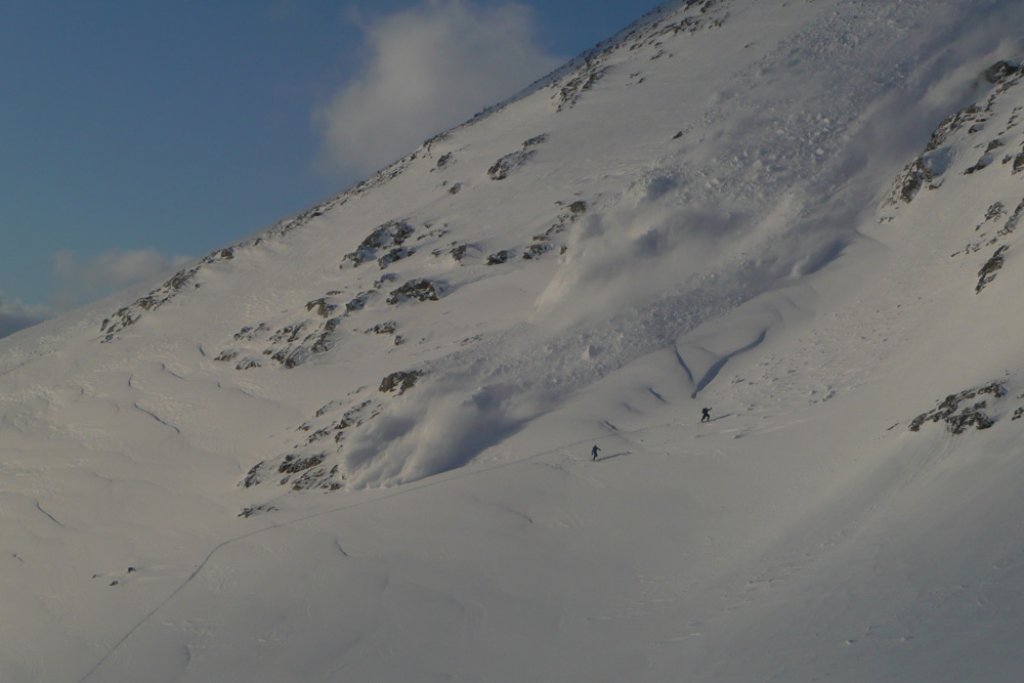 Ski tourers fleeing from an avalanche