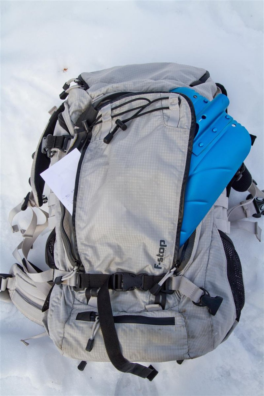 The two-layer front pocket holds a shovel blade (and with a size limit also a shovel handle and probe) on the lower level, while the upper level has plenty of room for map material
