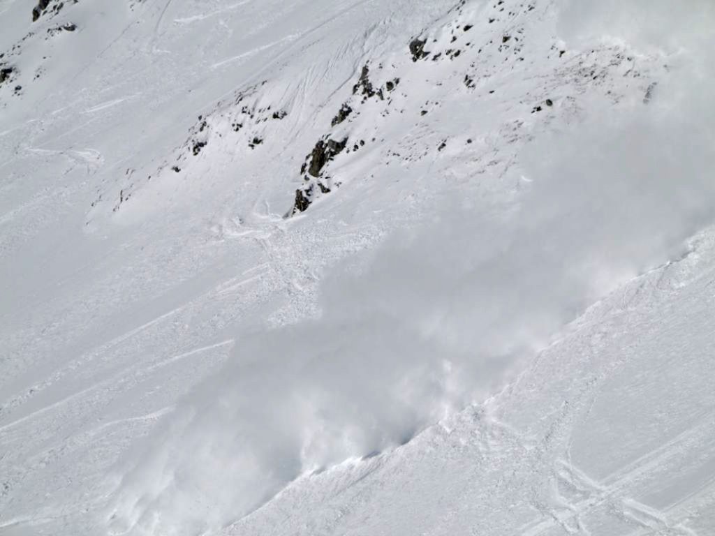 The snow slab triggered by the author develops into a sliding avalanche on steep terrain.