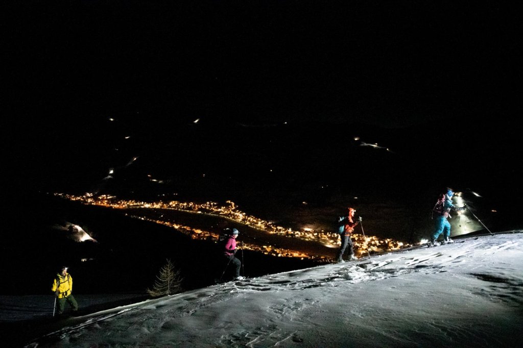 Ski tour over Livigno at night